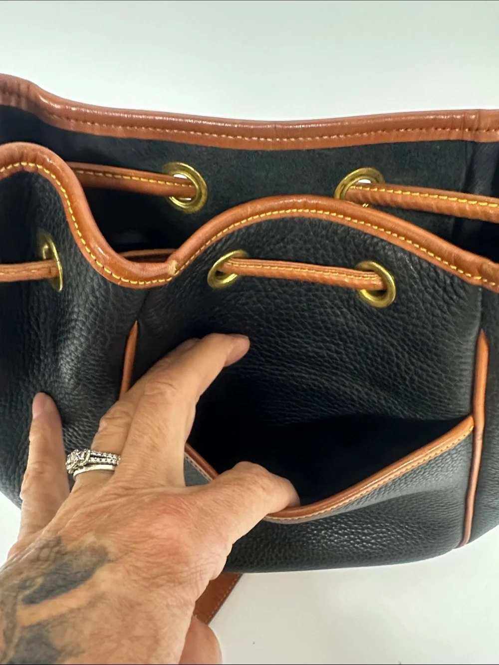 Dooney & Bourke Black Pebbled Leather Drawstring Bucket Bag with Tan Trim